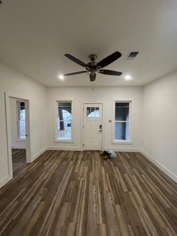 foyer with ceiling fan and dark wood-type flooring