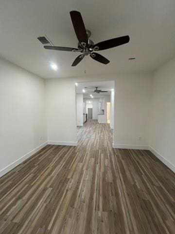 unfurnished living room with ceiling fan and dark hardwood / wood-style flooring