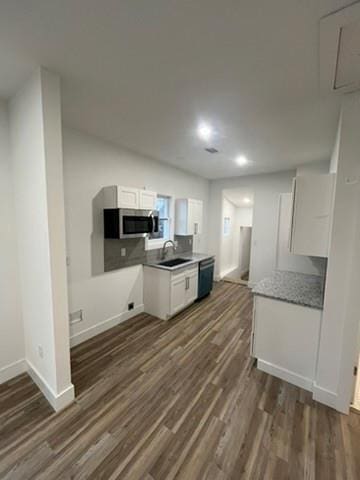 kitchen with dishwasher, dark hardwood / wood-style flooring, sink, and white cabinetry