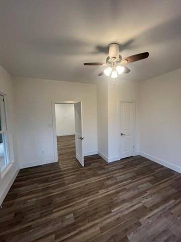 unfurnished room featuring ceiling fan and dark hardwood / wood-style floors