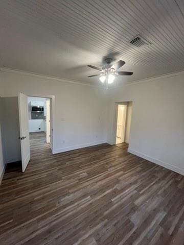 empty room with ceiling fan, dark hardwood / wood-style flooring, and crown molding