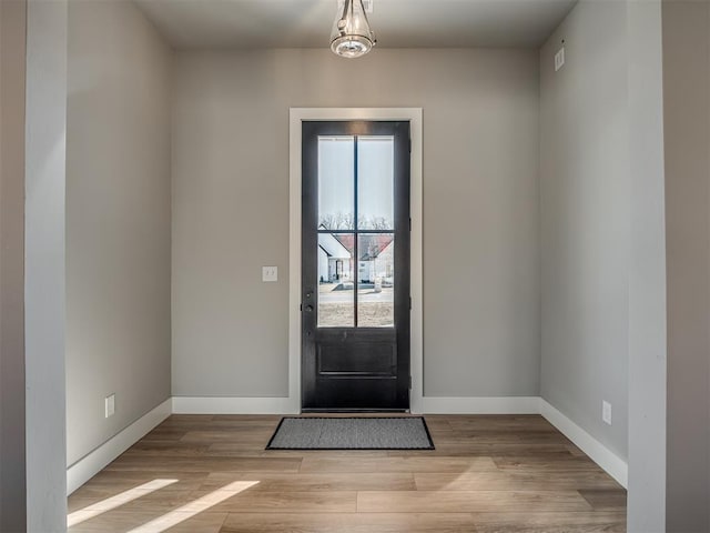 doorway with plenty of natural light and light hardwood / wood-style floors