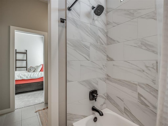 bathroom featuring tile patterned floors and tiled shower / bath