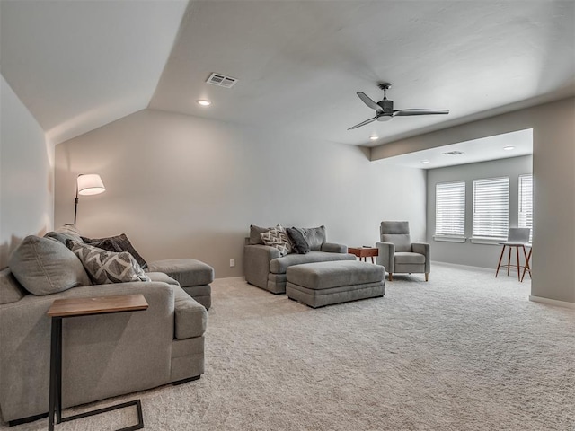 living room featuring ceiling fan, light carpet, and vaulted ceiling