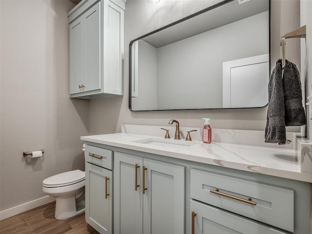 bathroom featuring hardwood / wood-style flooring, vanity, and toilet