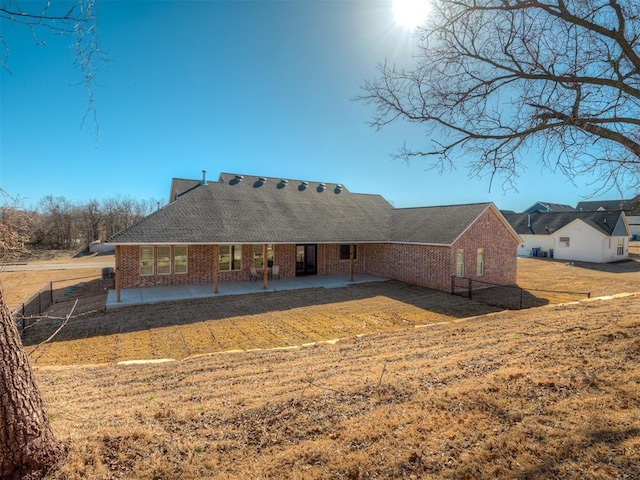 rear view of house featuring a yard and a patio