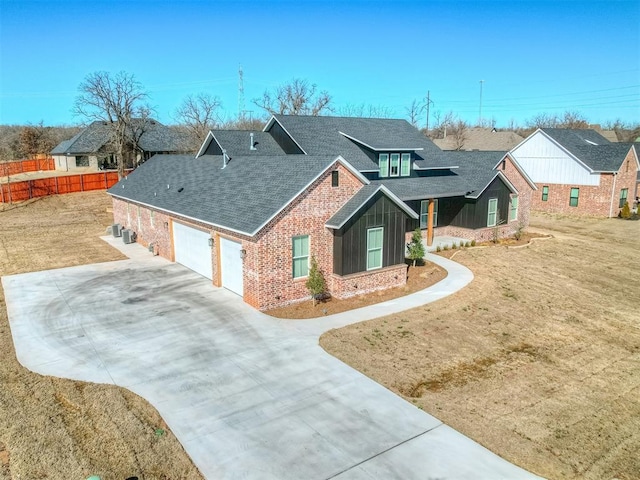 view of front of property featuring a garage and a front lawn