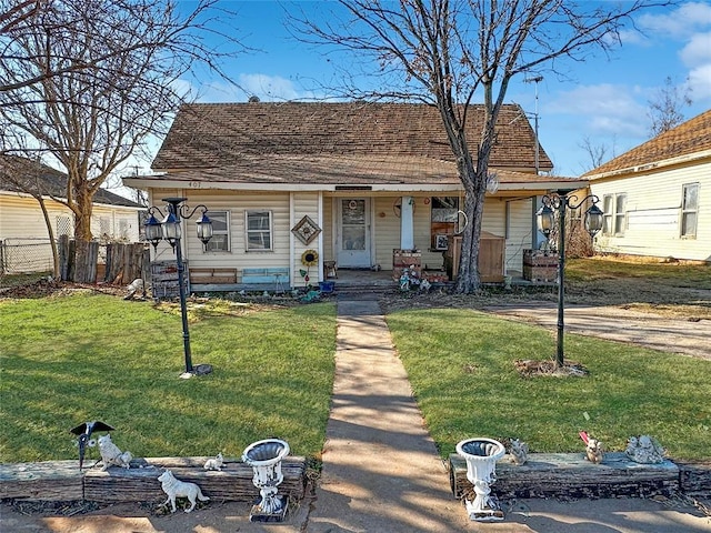 bungalow with a front yard and covered porch