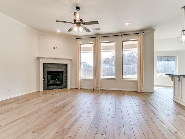 unfurnished living room featuring crown molding, ceiling fan, and light hardwood / wood-style flooring