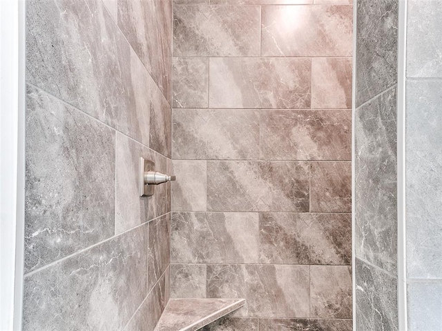 interior details featuring tiled shower