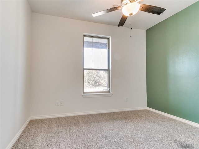 empty room with ceiling fan and carpet floors