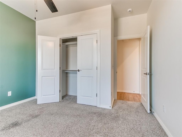 unfurnished bedroom featuring a closet and light colored carpet