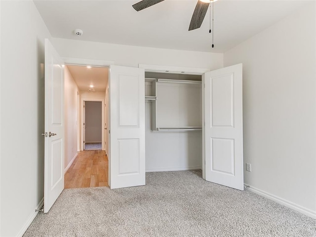 unfurnished bedroom with a closet, carpet flooring, and ceiling fan