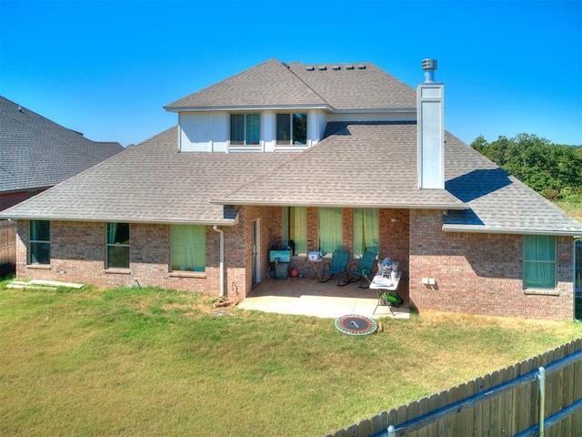 back of house featuring a patio and a lawn