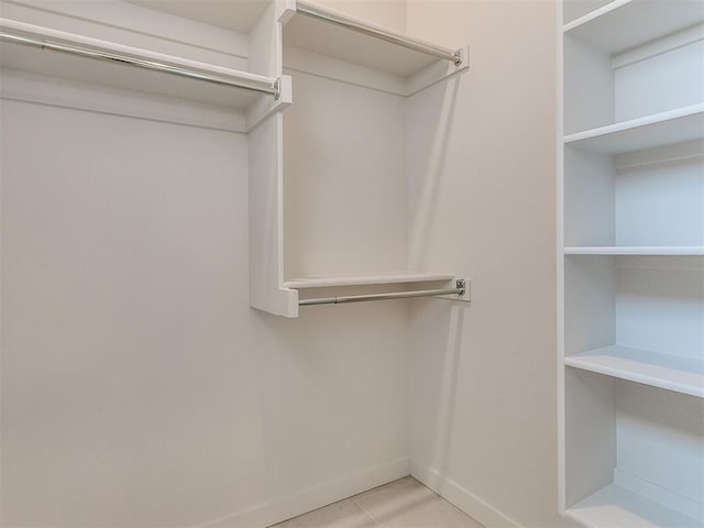 spacious closet featuring light tile patterned floors