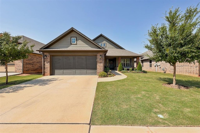 view of front of property with a front yard and a garage