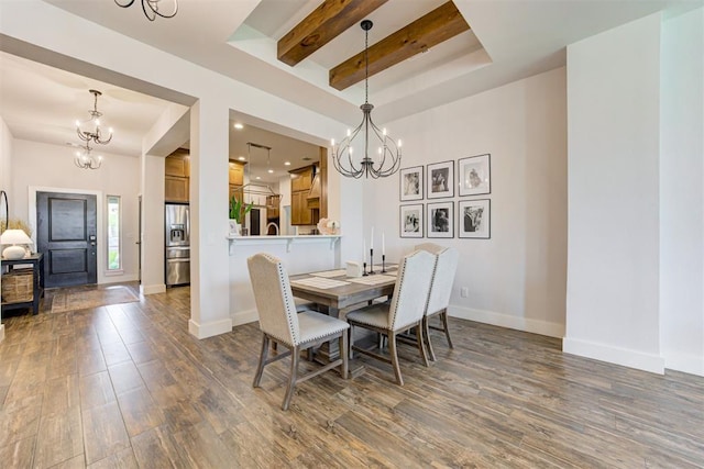 dining room with dark hardwood / wood-style flooring, a raised ceiling, and a notable chandelier