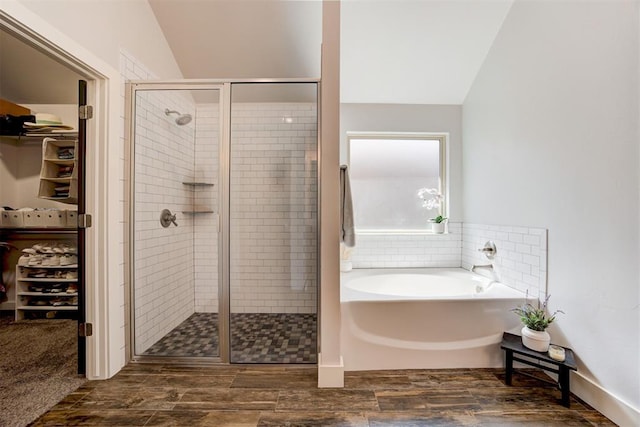 bathroom with separate shower and tub and vaulted ceiling