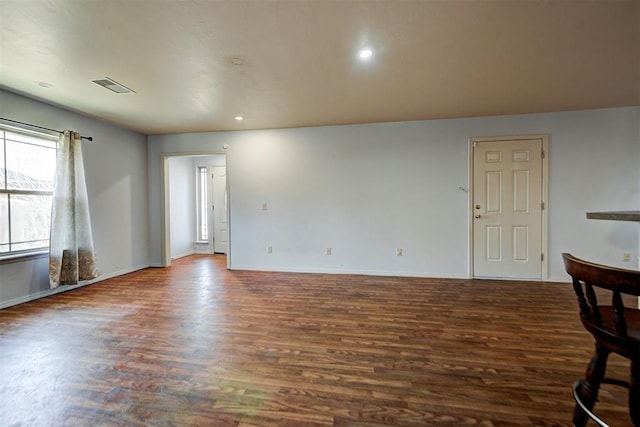 spare room with visible vents, recessed lighting, baseboards, and wood finished floors
