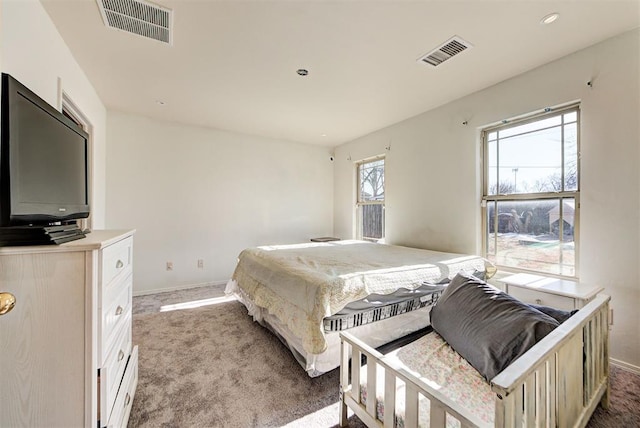 carpeted bedroom featuring baseboards, recessed lighting, and visible vents