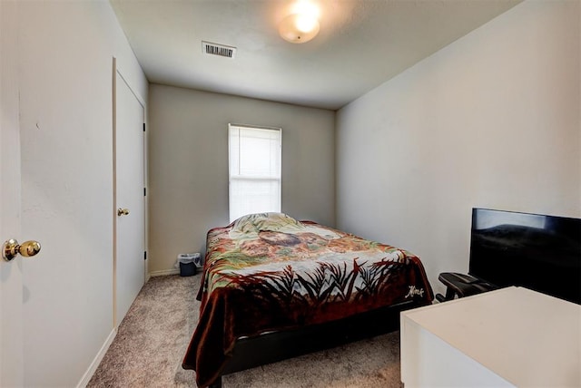 bedroom featuring light colored carpet, baseboards, and visible vents