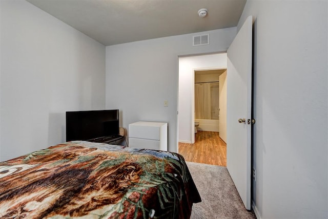 carpeted bedroom with visible vents