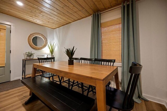 dining area featuring hardwood / wood-style flooring and wooden ceiling