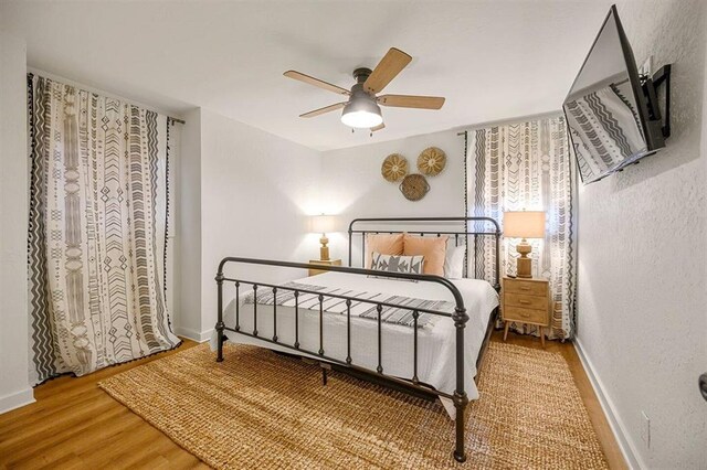 bedroom featuring hardwood / wood-style flooring and ceiling fan