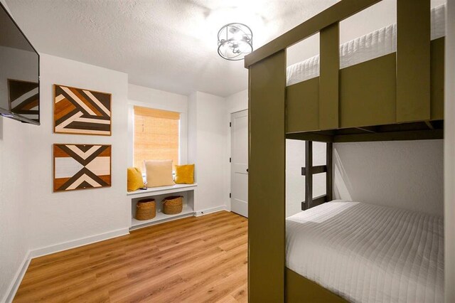 unfurnished bedroom with wood-type flooring and a textured ceiling