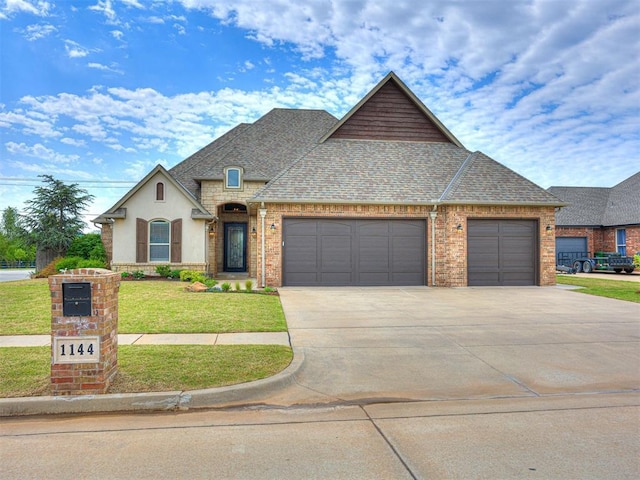 view of front facade featuring a front yard and a garage