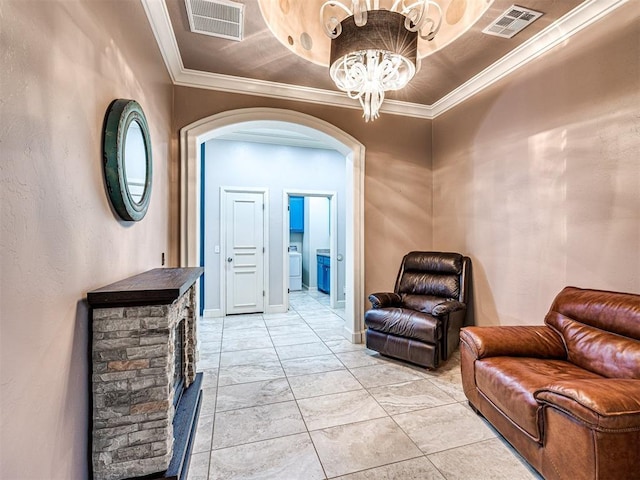 hall with washer / dryer, ornamental molding, and a notable chandelier