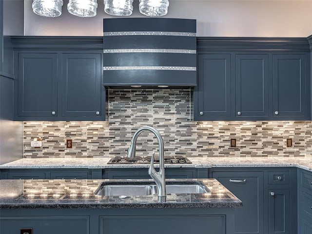 kitchen featuring sink, blue cabinets, and tasteful backsplash