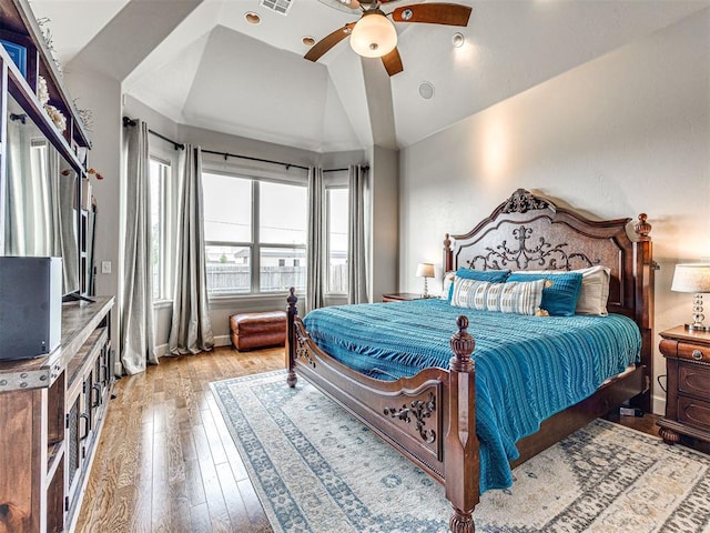 bedroom featuring ceiling fan, hardwood / wood-style floors, and lofted ceiling