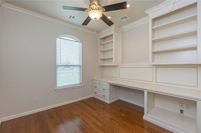 unfurnished office with crown molding, dark wood-type flooring, ceiling fan, and built in desk