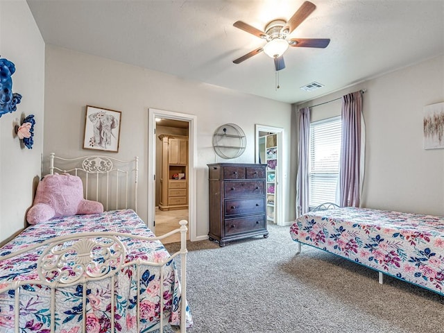 bedroom featuring ceiling fan and carpet