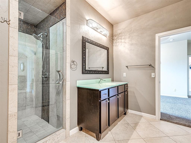 bathroom featuring tile patterned flooring, walk in shower, and vanity