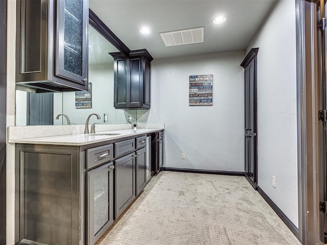 interior space featuring sink and light carpet