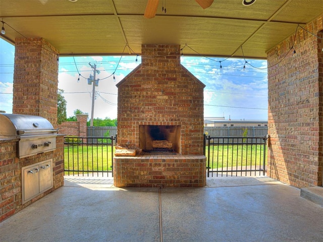 view of patio featuring grilling area and an outdoor brick fireplace