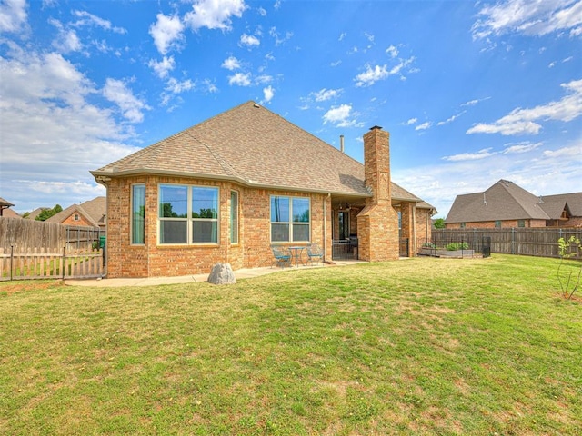 back of property featuring a patio and a yard