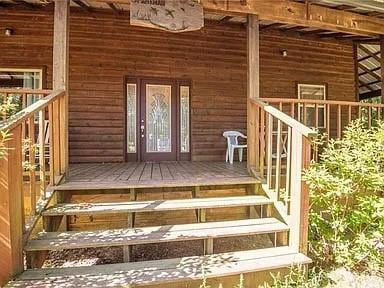 doorway to property featuring a porch