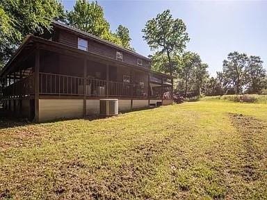 exterior space with a lawn and central AC unit