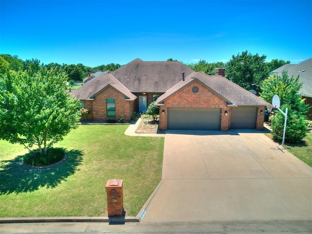 view of front of home with a front lawn and a garage