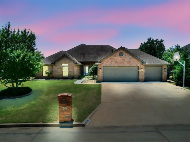 view of front of house with a lawn and a garage