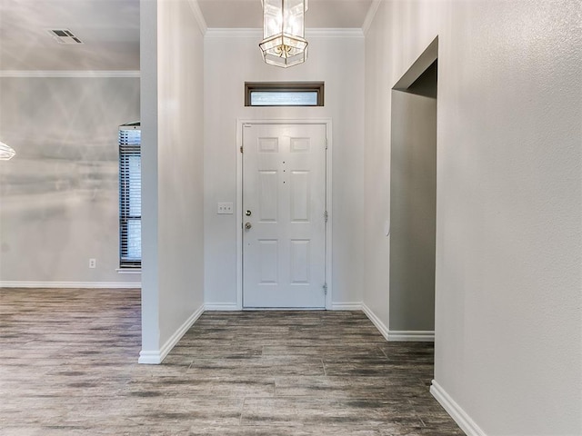 entryway featuring hardwood / wood-style floors and crown molding