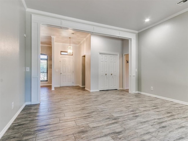 spare room with hardwood / wood-style floors and ornamental molding