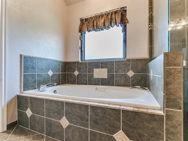 bathroom featuring tiled tub and tile patterned flooring