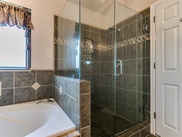 bathroom with separate shower and tub