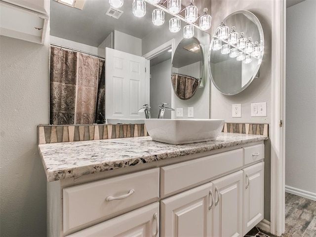 bathroom with hardwood / wood-style floors and vanity