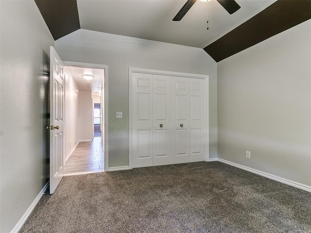 unfurnished bedroom with carpet flooring, ceiling fan, lofted ceiling, and a closet