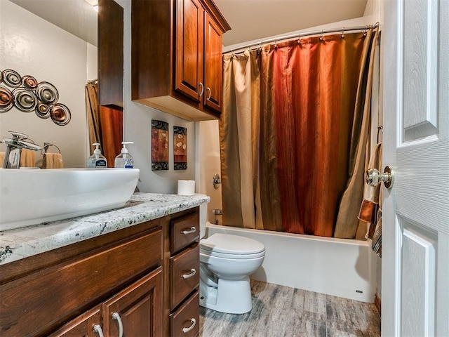 full bathroom with toilet, hardwood / wood-style floors, vanity, and shower / tub combo with curtain